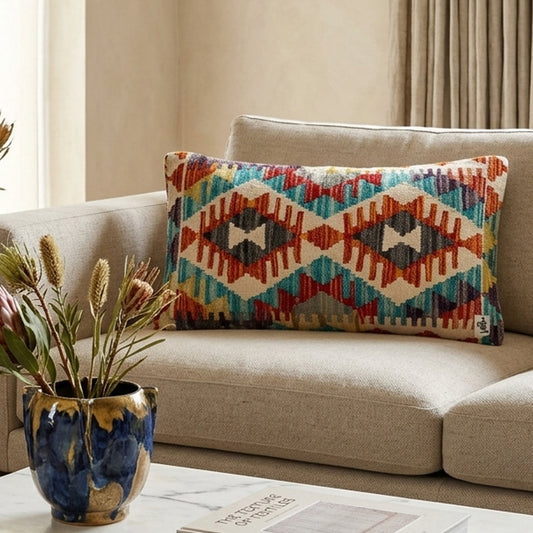 Rectangular kilim cushion cover with turquoise geometric diamond patterns and warm accent colors