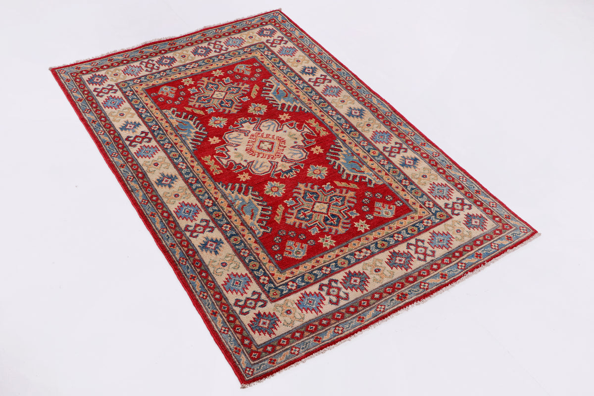 Red and blue geometric area rug with ornate medallion center, 147x99 cm