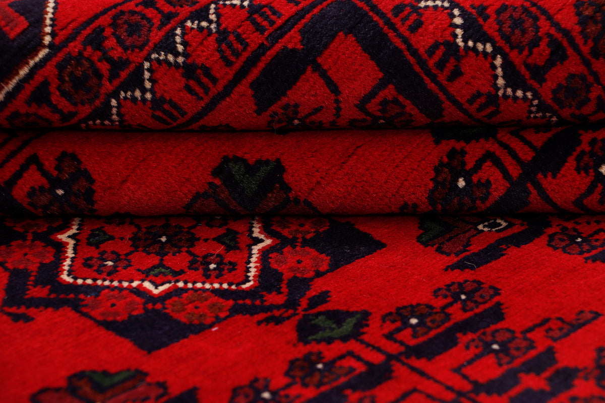 Khal Mohammadi red rug detail with layered geometric bands and patterned edge