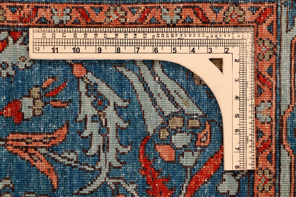 Blue oriental rug corner with measuring tape along edge and ruler scale