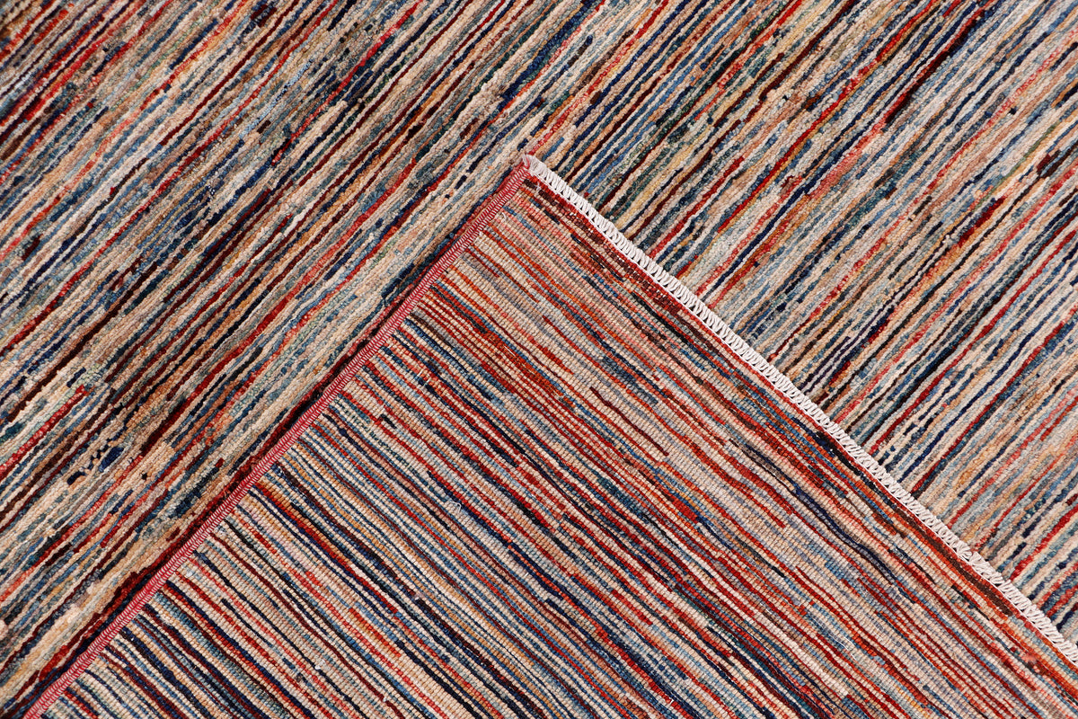 Striped rug corner detail with multicolor bands and folded edge