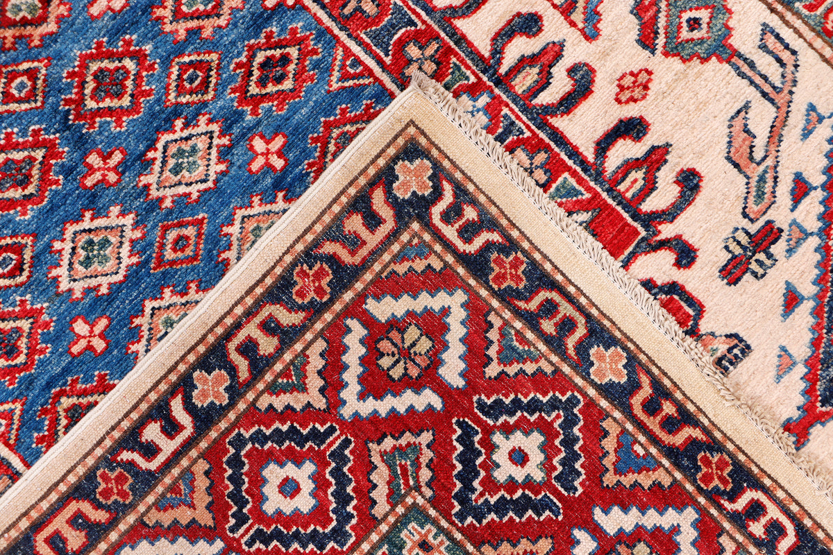 Blue Kazak rug corner with red diamond medallion pattern