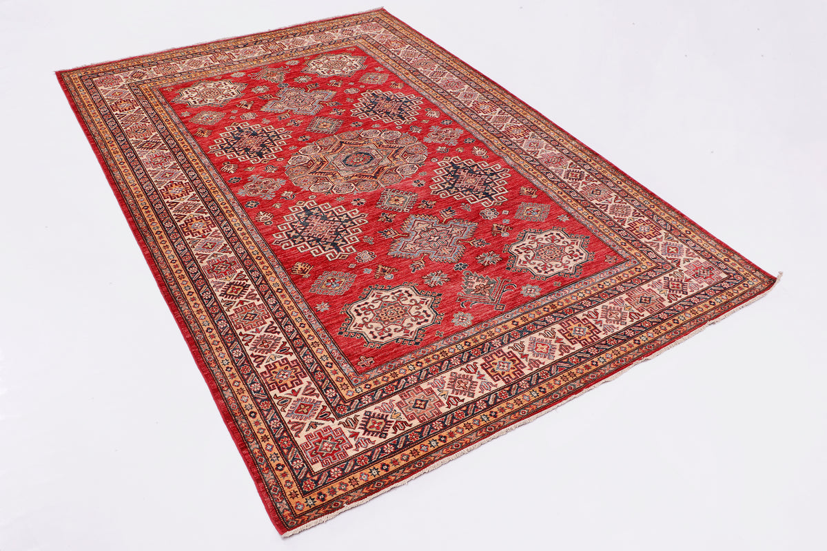 Red and multicolor decorative rug with ornate border and central pattern.