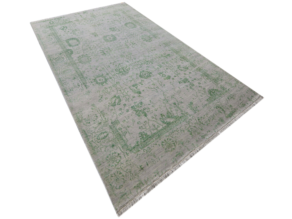 Light gray rug with green distressed medallion pattern, corners visible