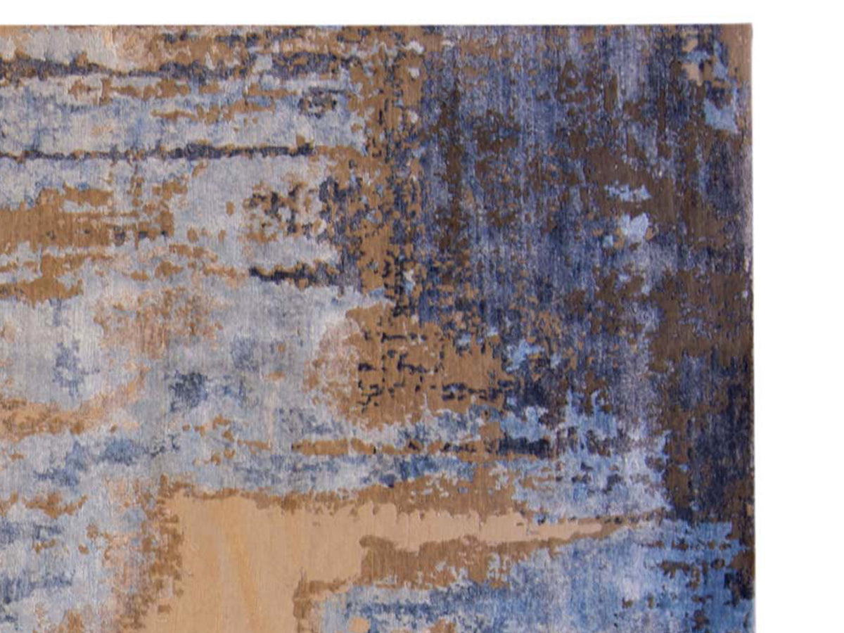 Close-up of modern Tibetan rug with blue, beige, and dark distressed texture