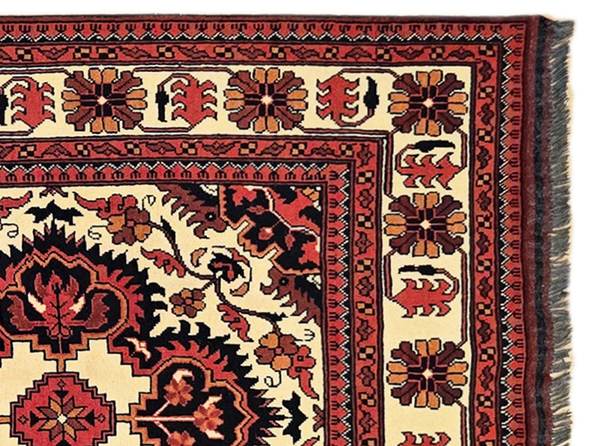 Cream Afghan rug with red and dark motifs; detailed geometric border with inner panel lines.