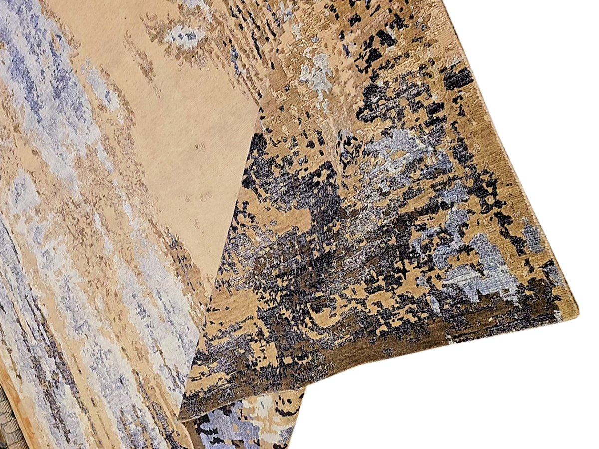 Modern Tibetan rug with beige background and black-and-blue speckled distressed design