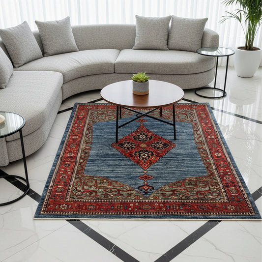 Area rug displayed in a living room setting with blue field and red diamond medallion.