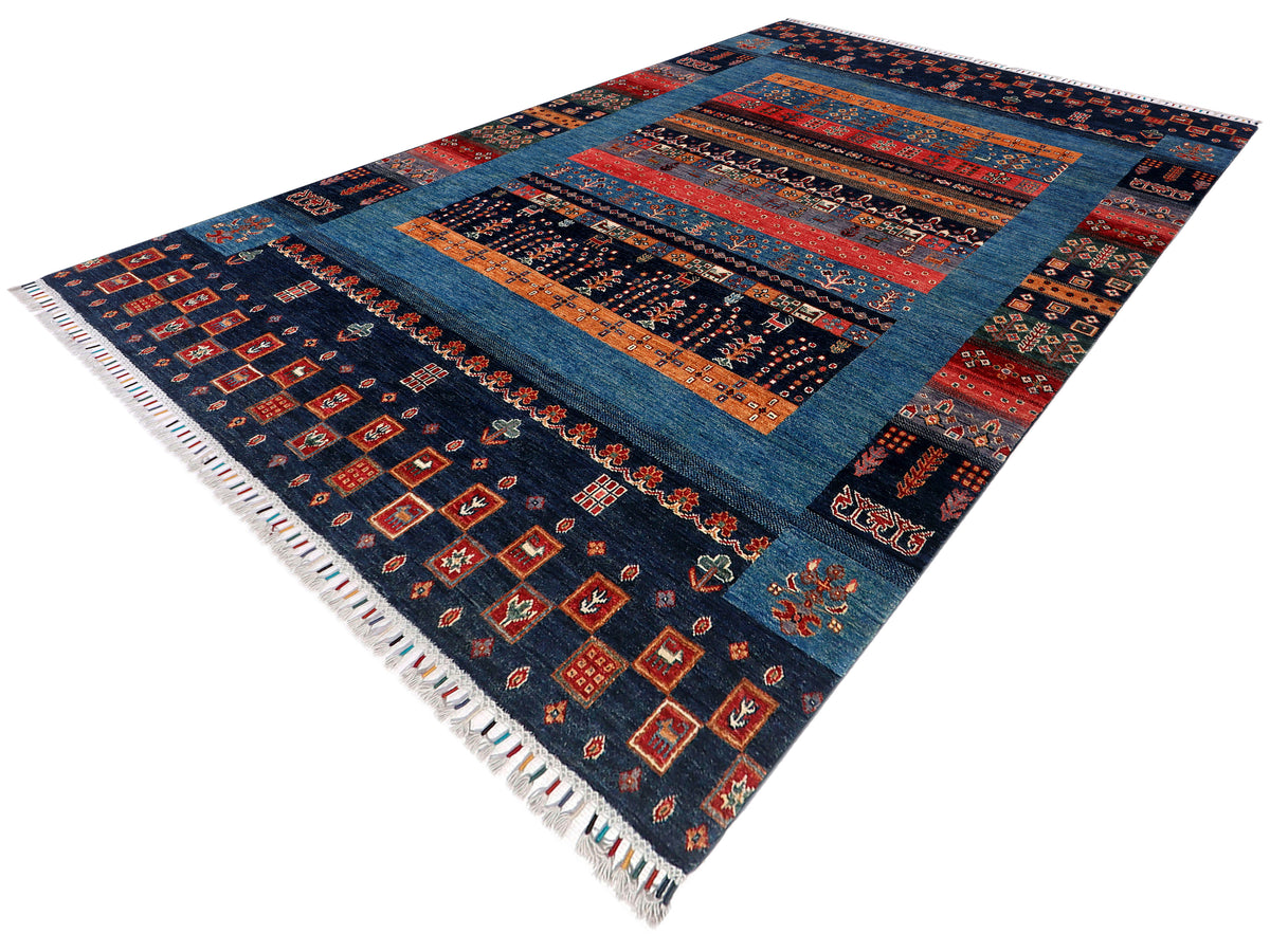 Gabbeh Afghan rug angled view with navy blue medallion center and multicolor borders