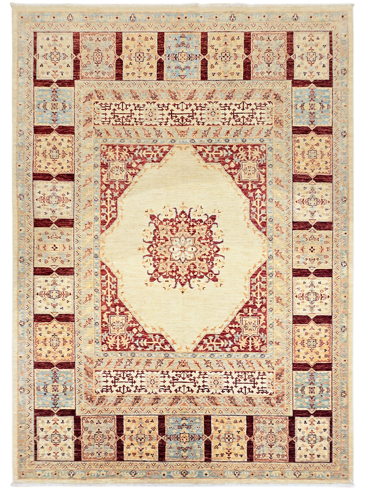 Framed view of Ariana rug with cream medallion, red arch motif, and multicolor tile border.