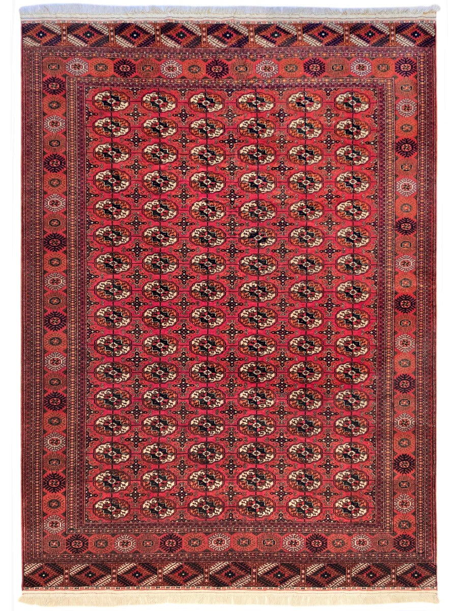 Red area rug with central medallion pattern and ornate geometric border