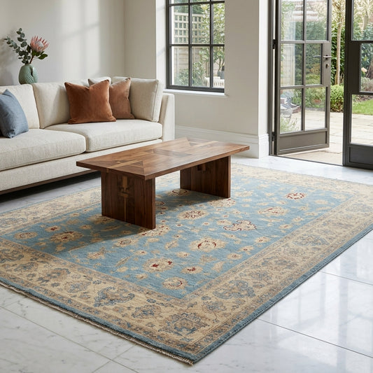 Blue and beige ornate area rug with floral motifs and decorative border