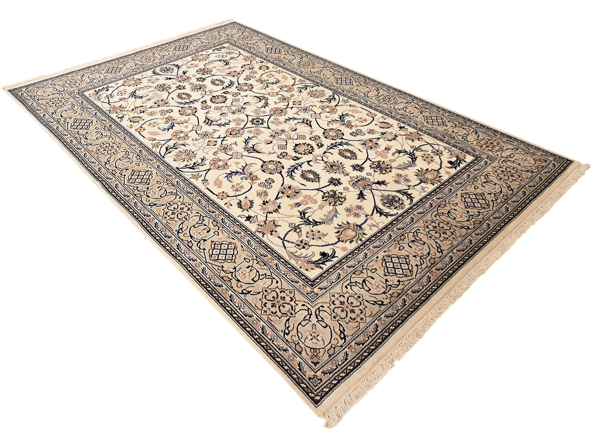 Nain rug with cream field, blue patterned border, and floral medallion design, fringed corners
