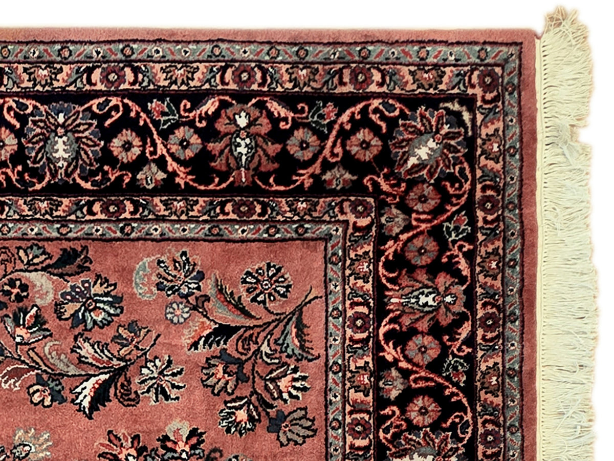 Dark border floral rug panel with rust center and cream fringe trim