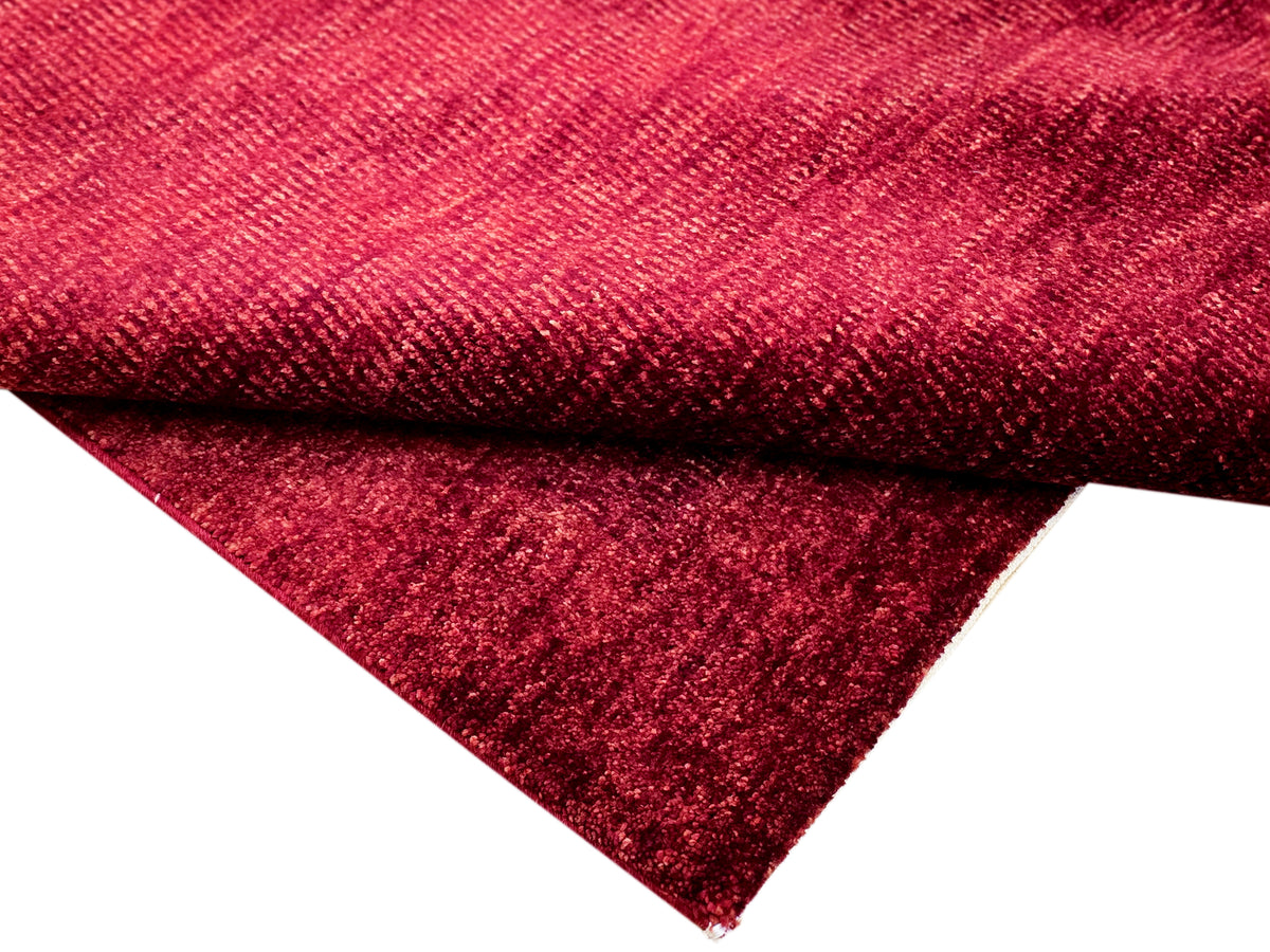 Red rug edge with close-up textured pile