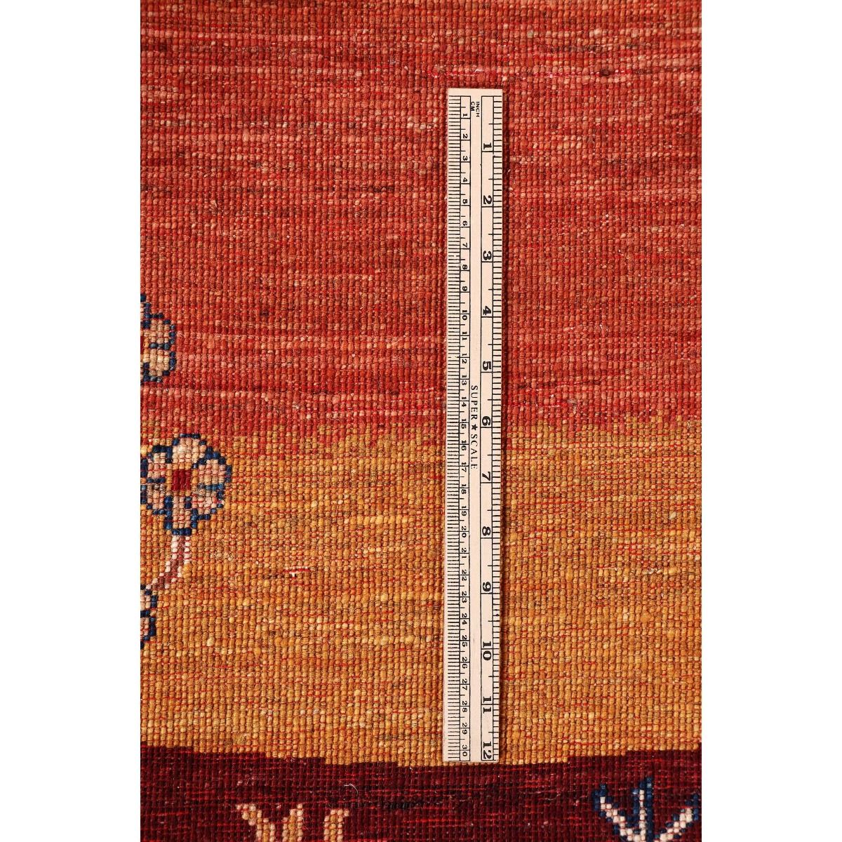 Rust-red rug close-up with short geometric texture and central measuring stripe