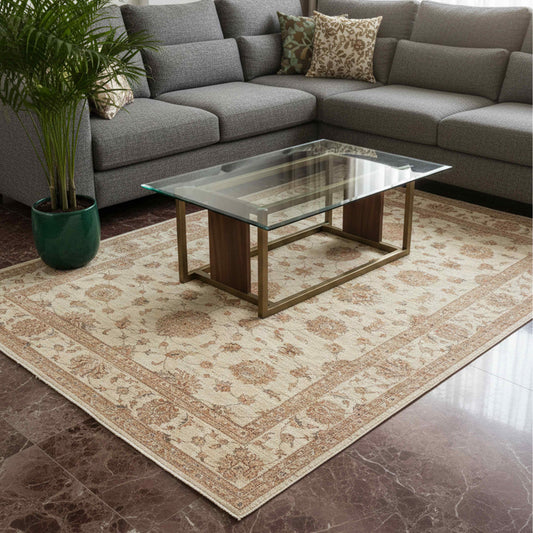 Cream rug with rust floral motifs and detailed border, laid on a living room floor.