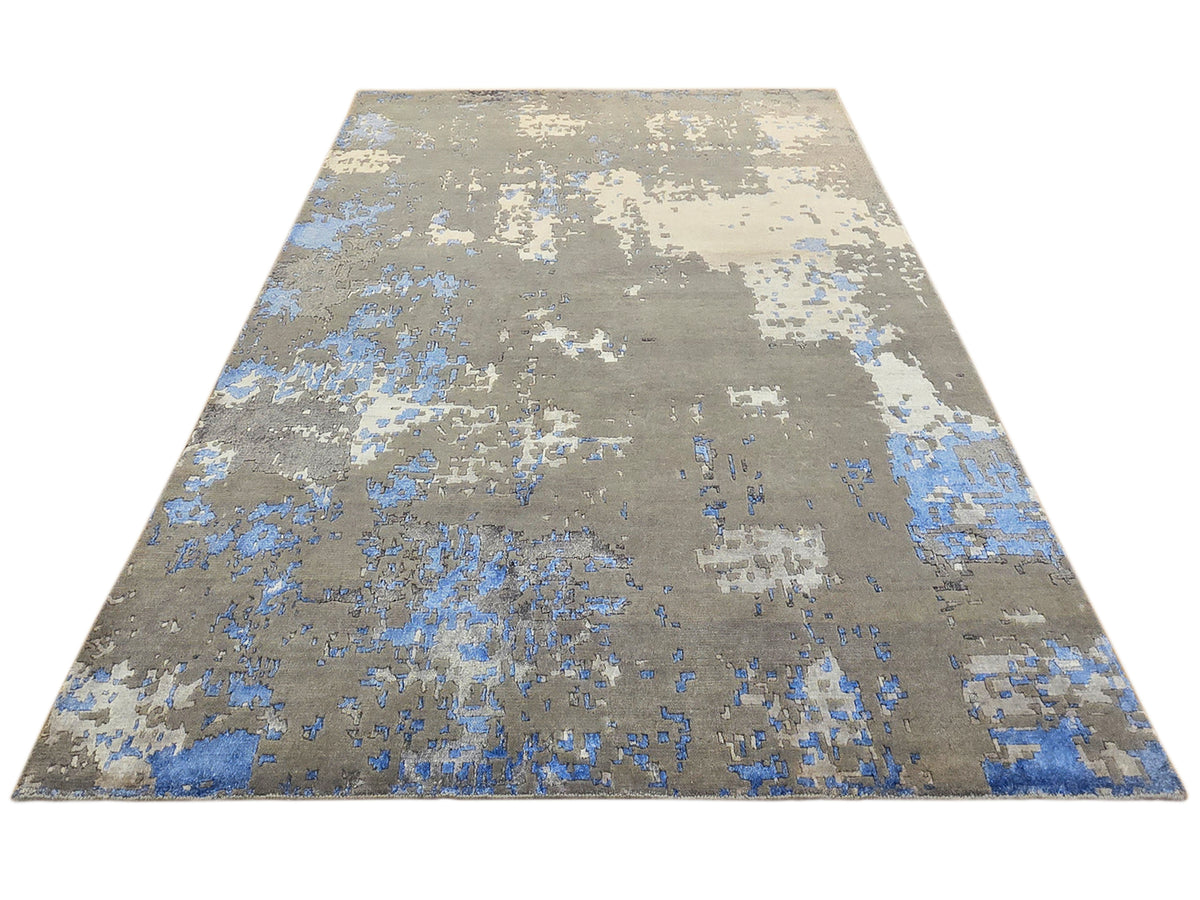 Rectangular abstract area rug in gray, blue, and cream, top view