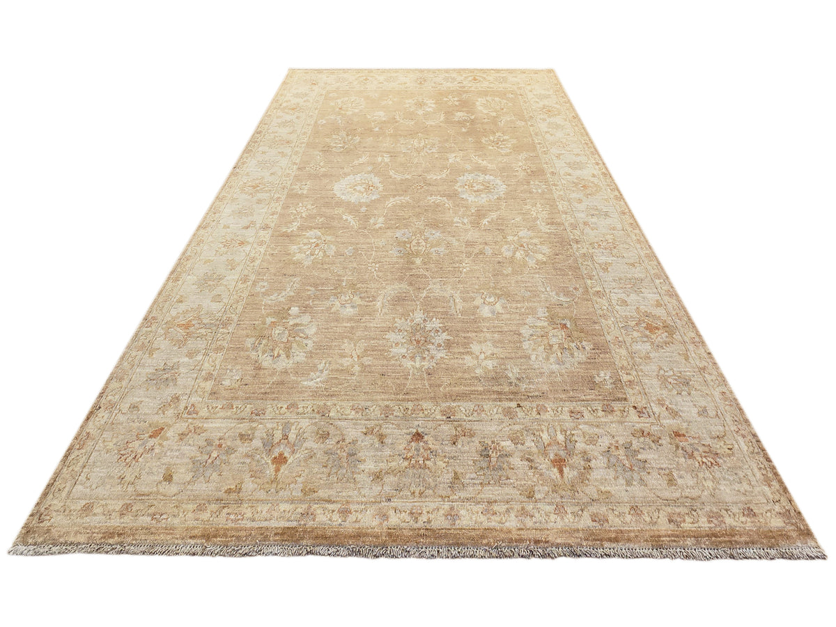 Beige distressed area rug with allover medallion pattern and short fringed edges