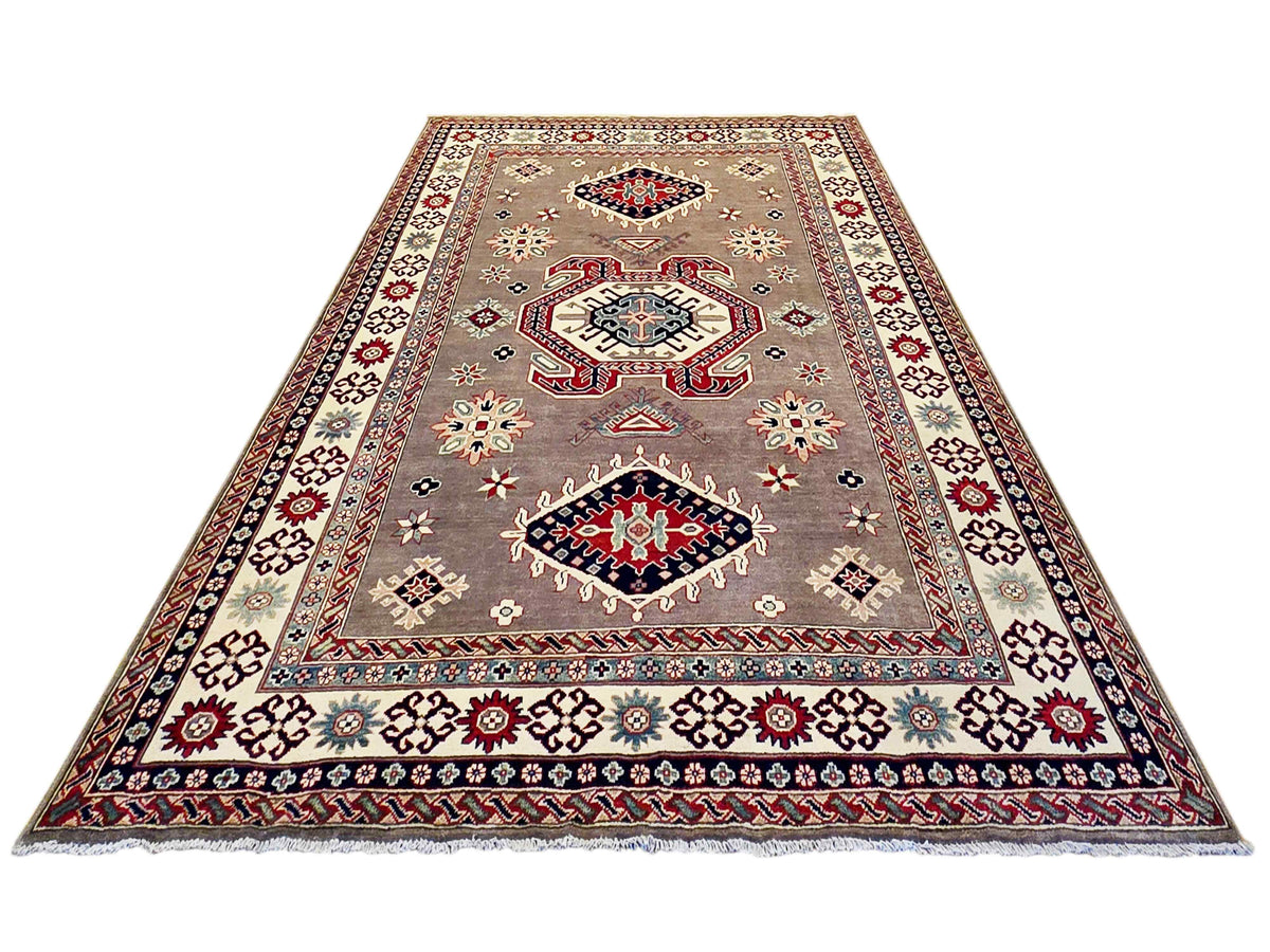 Kazak rug with beige-gray tone, red and blue geometric pattern, and multicolor border