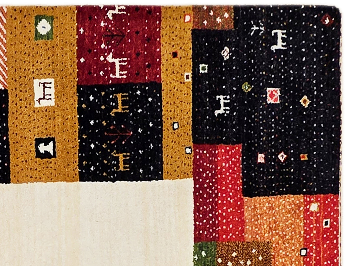 Close-up patchwork rug with yellow, red, navy blocks and speckled weave