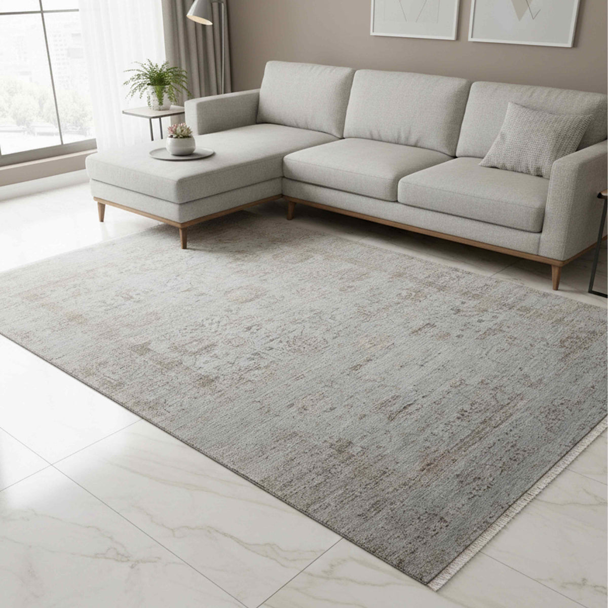 Light gray distressed area rug with large mottled abstract pattern