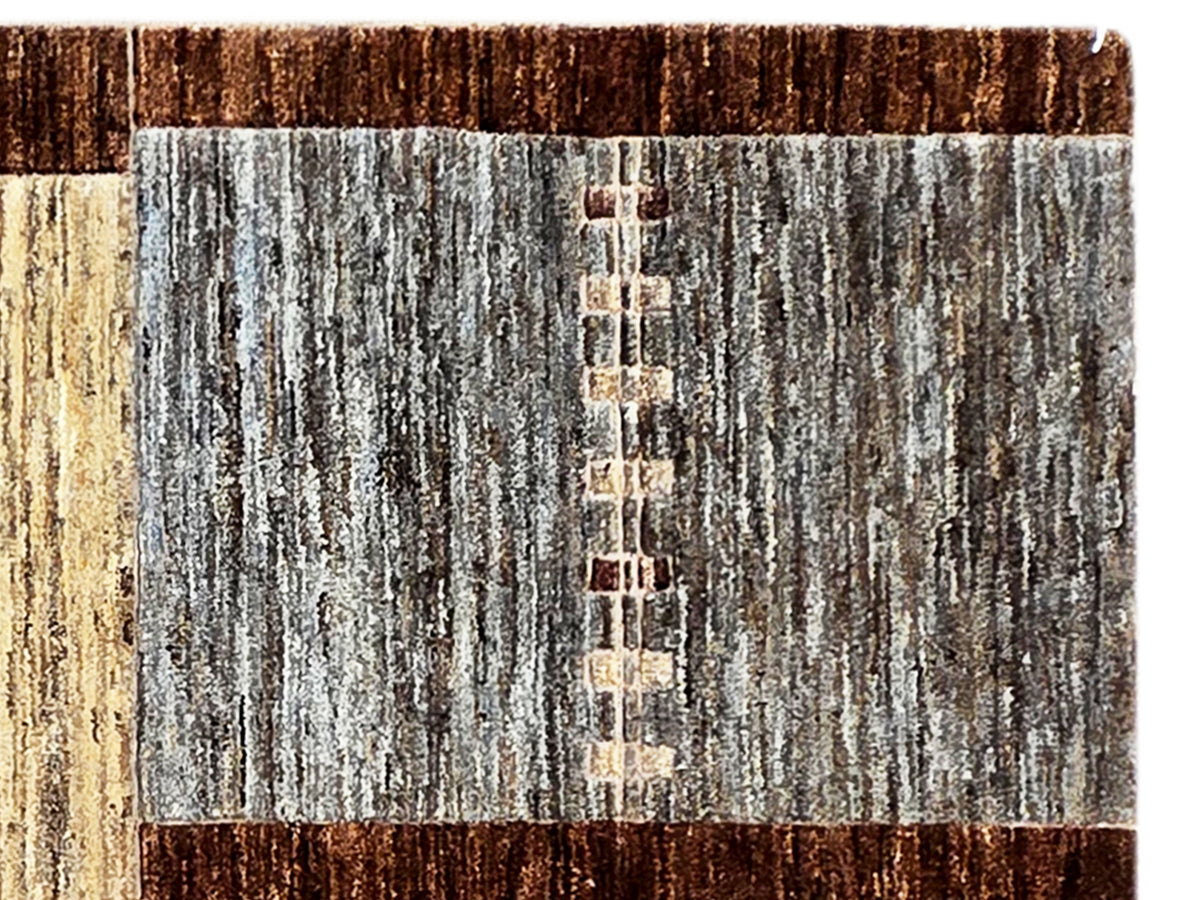 Area rug detail with gray vertical panel and dark brown border, textured weave