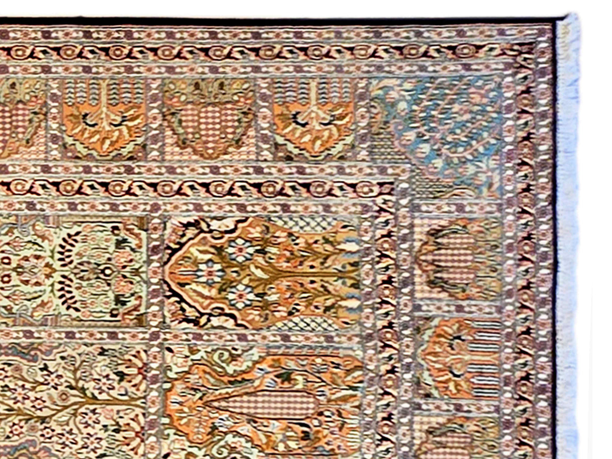 Close-up of multicolor ornate rug border with central medallion motifs and light edge.