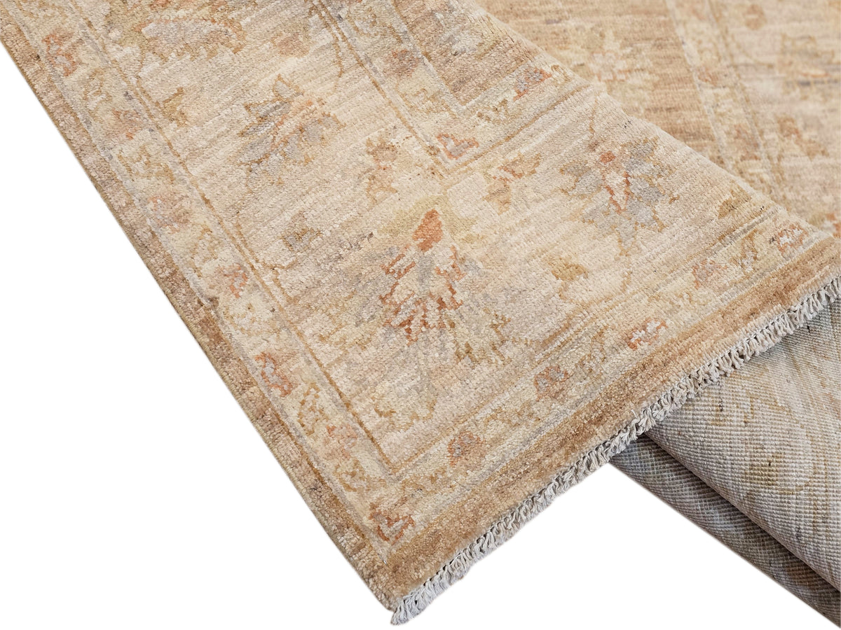 Beige rug corner with textured weave and short fringed edge detail