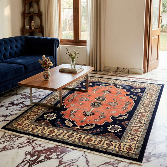 Rectangular ornate rug with orange center medallion, navy field, cream border and fringe