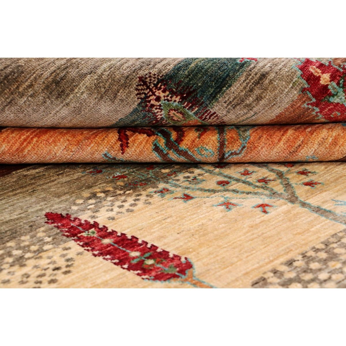 Close-up of multicolor patterned rug pile with beige, rust, and teal accents