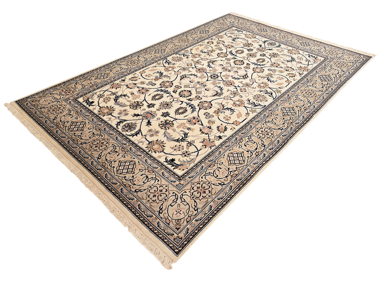 Nain rug with cream ground, blue-gray ornamental border, central floral motif, fringed edges