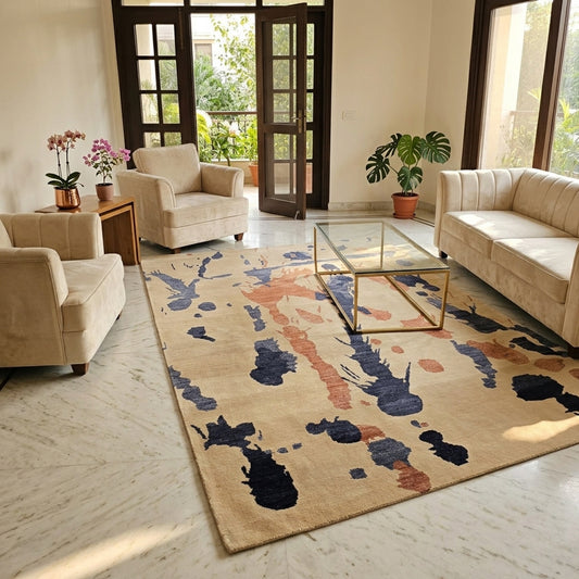 Beige abstract rug with blue and rust print, shown in a living room setting