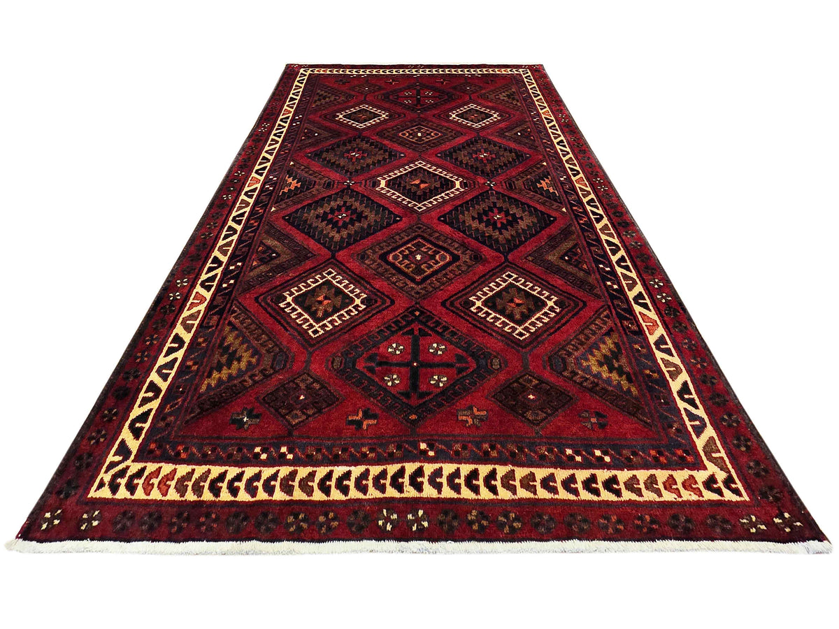 Red and navy geometric rug with cream border and diamond lattice pattern