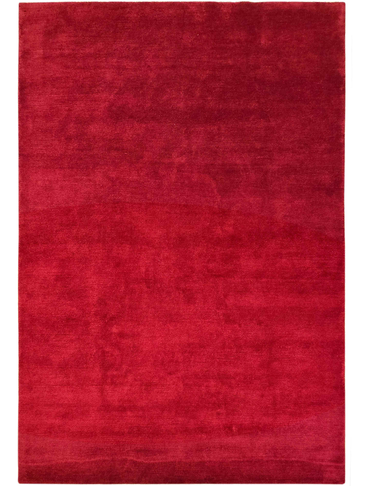 Solid red rectangular rug with mottled finish and tightly bound perimeter