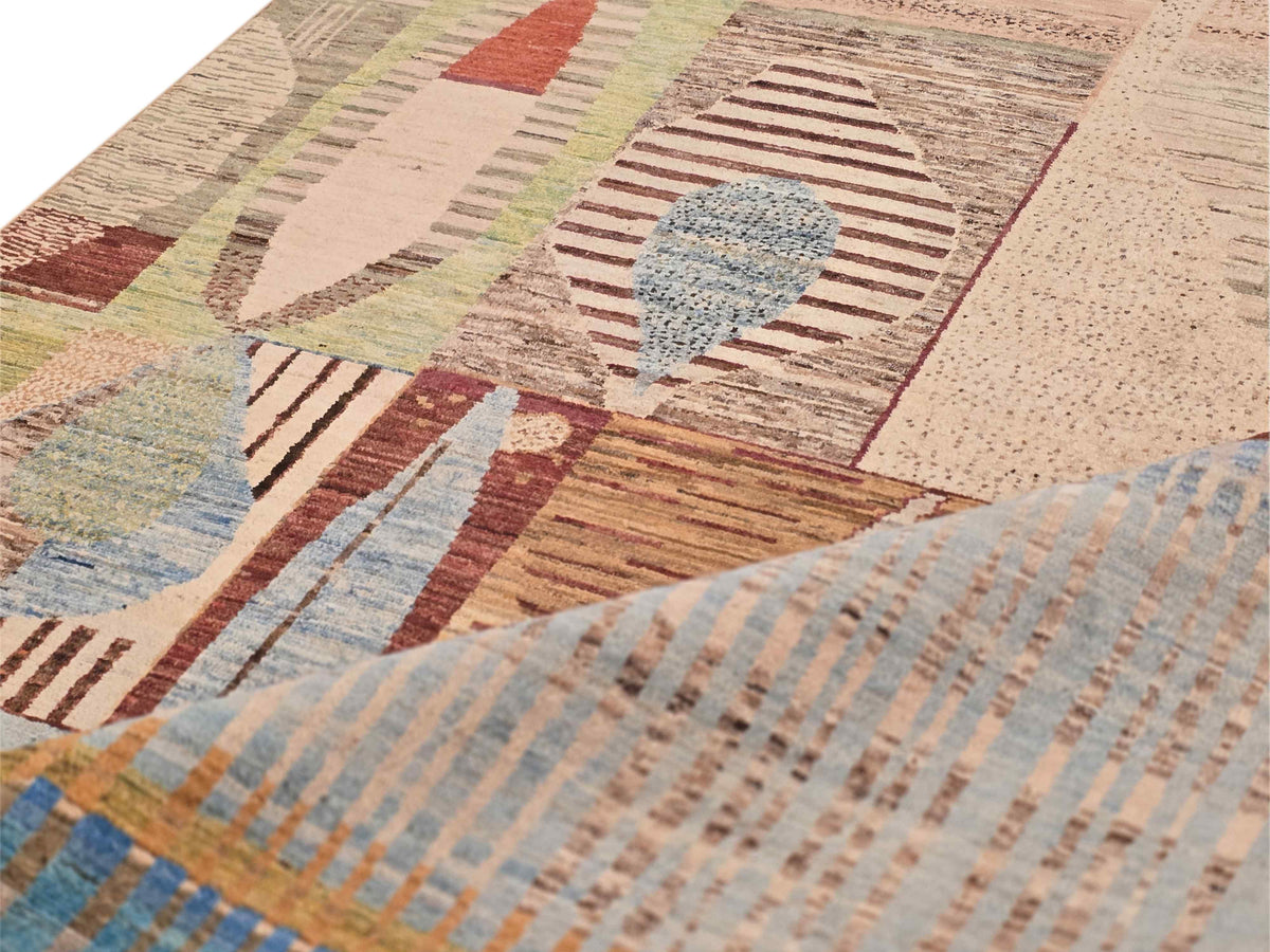 Close-up of multicolor geometric rug pattern with beige ground, blue accents, and texture.