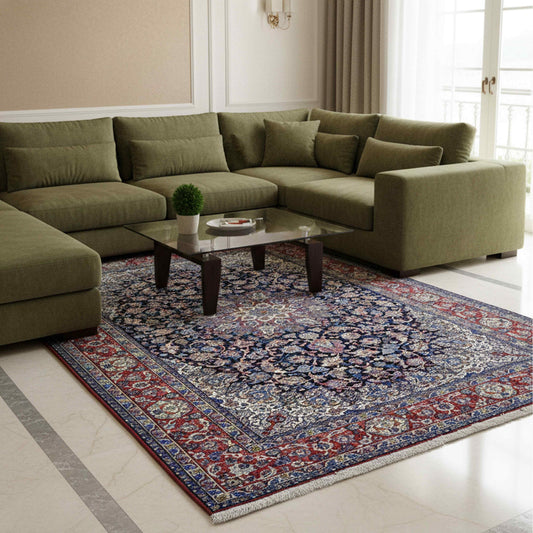Multicolor Persian-style area rug with blue field and red floral border, shown in living room