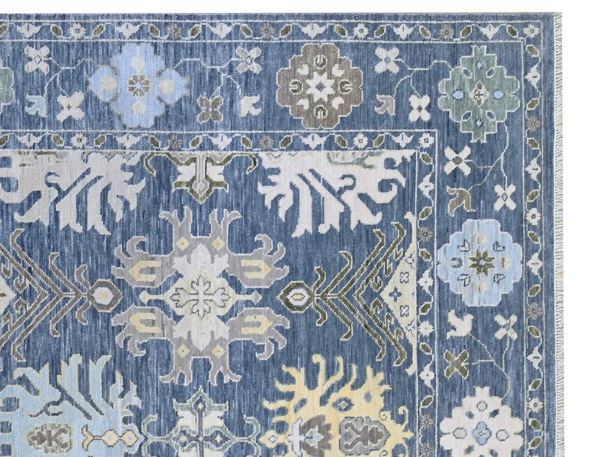 Oushak rug detail with blue ground and light floral medallion motifs, visible weave texture