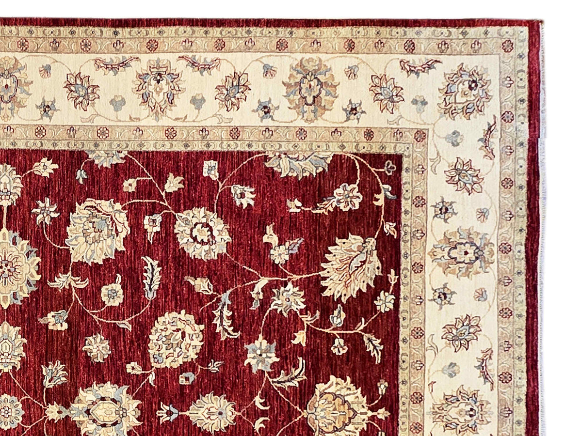 Rug border detail: red floral ground with cream medallions and dark trim