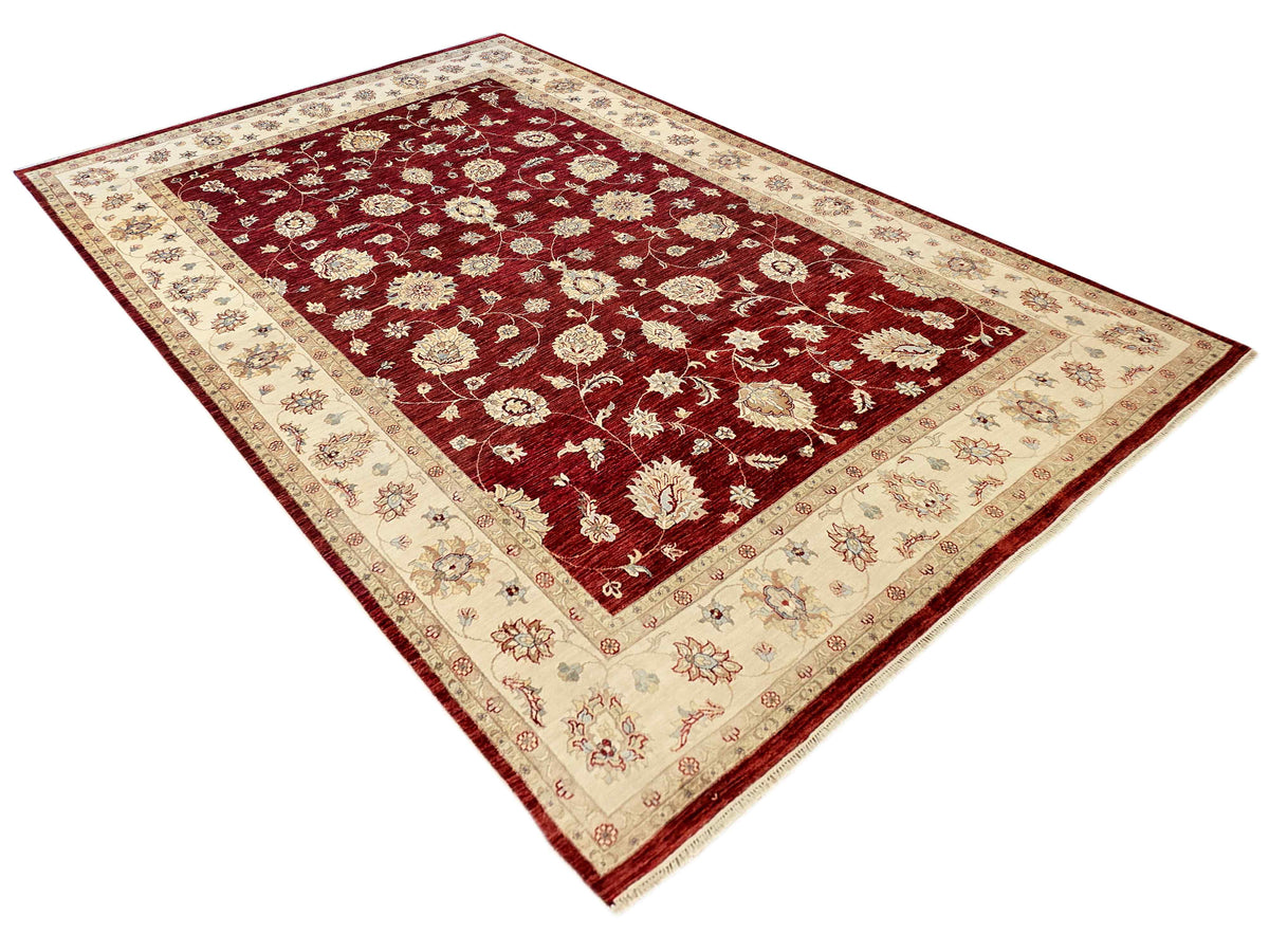 Large floral area rug with deep burgundy field, cream border, and decorative corner design