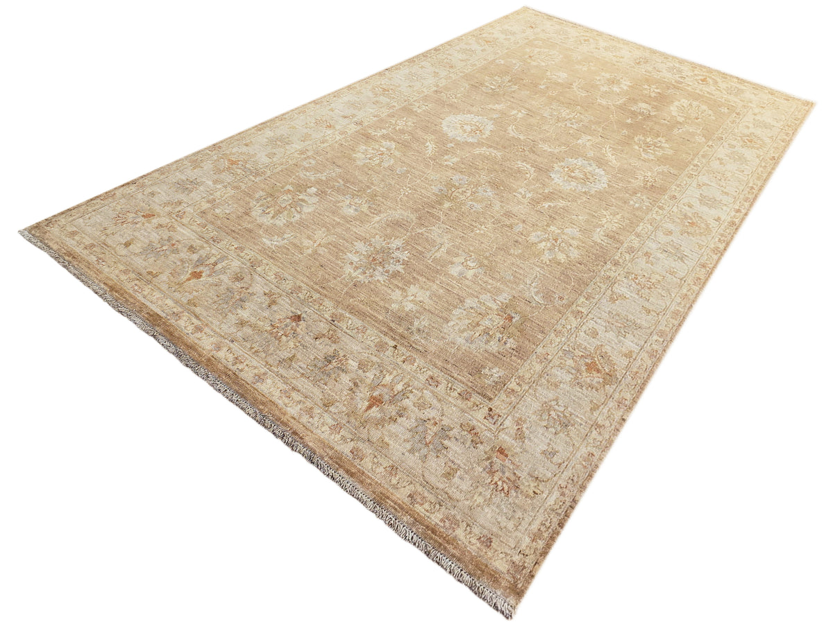 Beige area rug featuring ornate abstract allover pattern and short fringes on edges