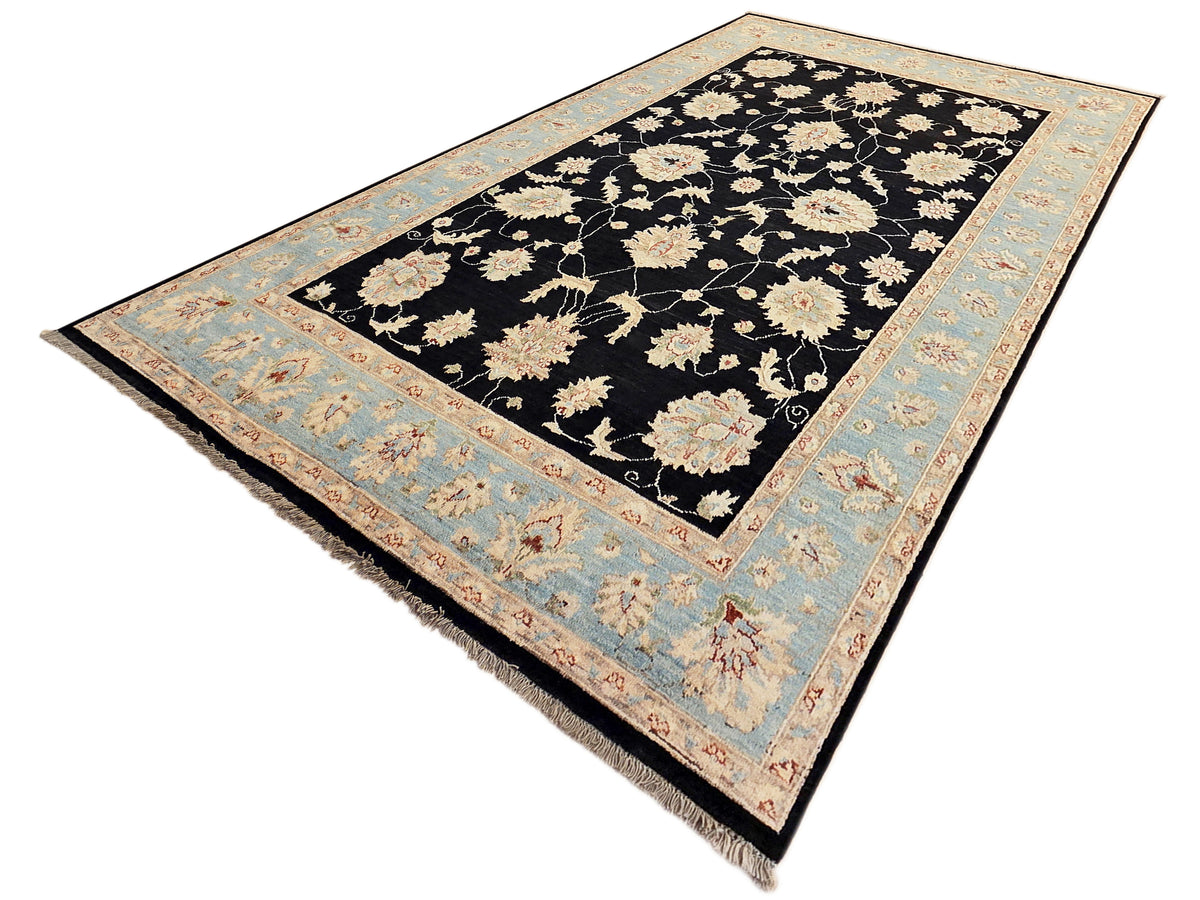 Black floral rug with light blue border, cream and blush flower pattern, corner blooms