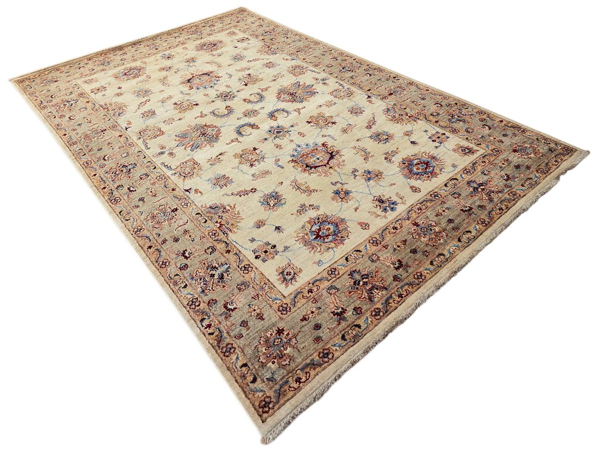 Cream area rug with central medallion and detailed multicolor floral motifs; beveled edge