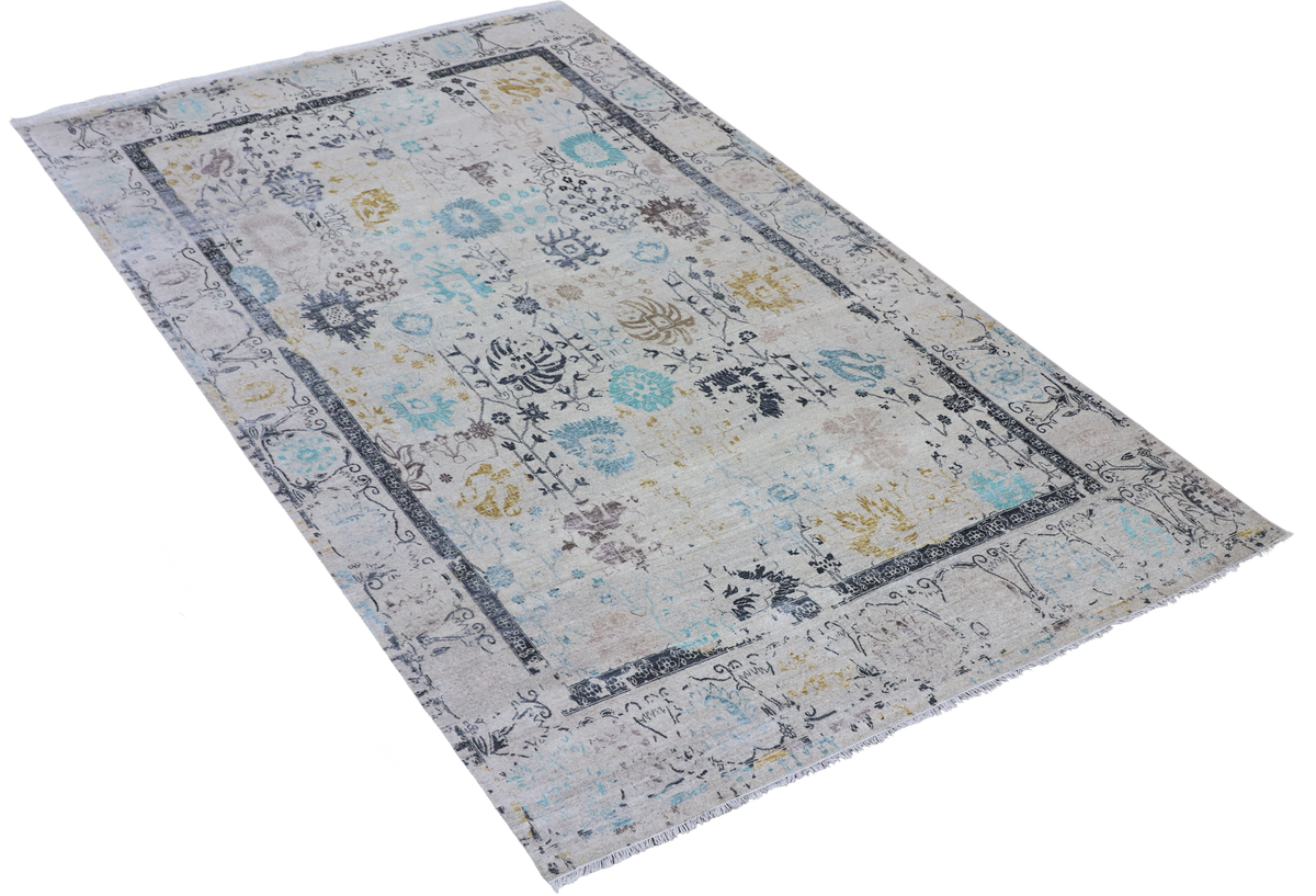 Rectangular light gray area rug angled view with blue and yellow ornate border pattern.