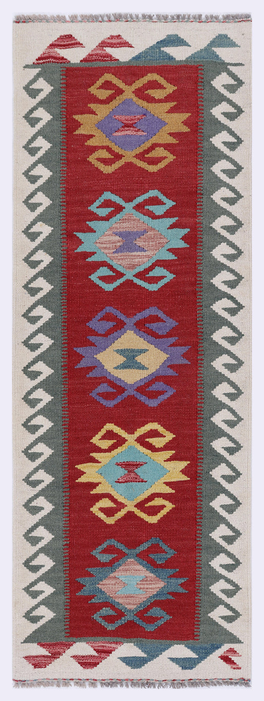 Rectangular red kilim rug with multicolor geometric medallion pattern and zigzag border