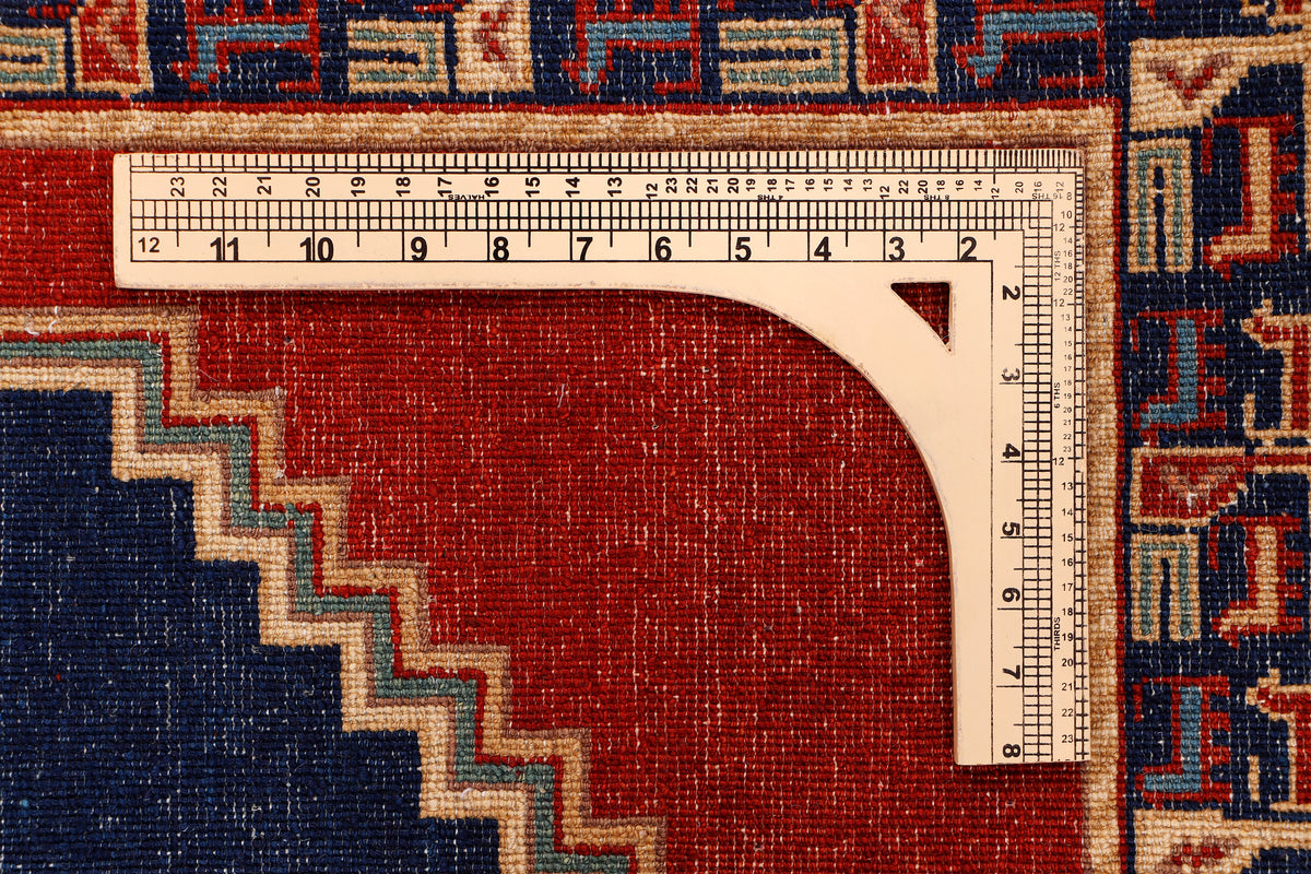 Red rug edge shown with measuring tape; cream-trimmed border