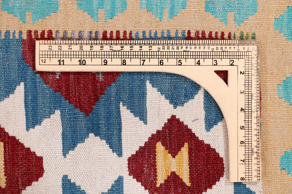 Kilim runner rug close-up with geometric diamond pattern and measuring tape along edge