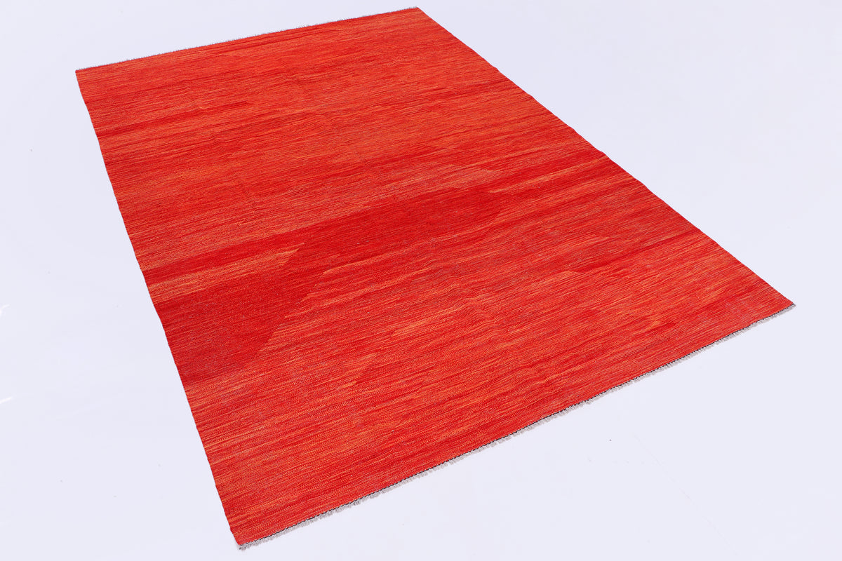Red rug laid flat, showing smooth textured surface