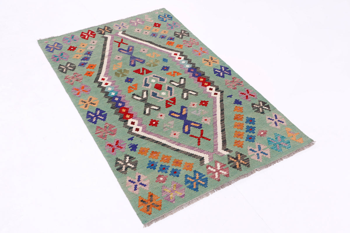Green kilim rug with central geometric medallion and multicolor diamond border