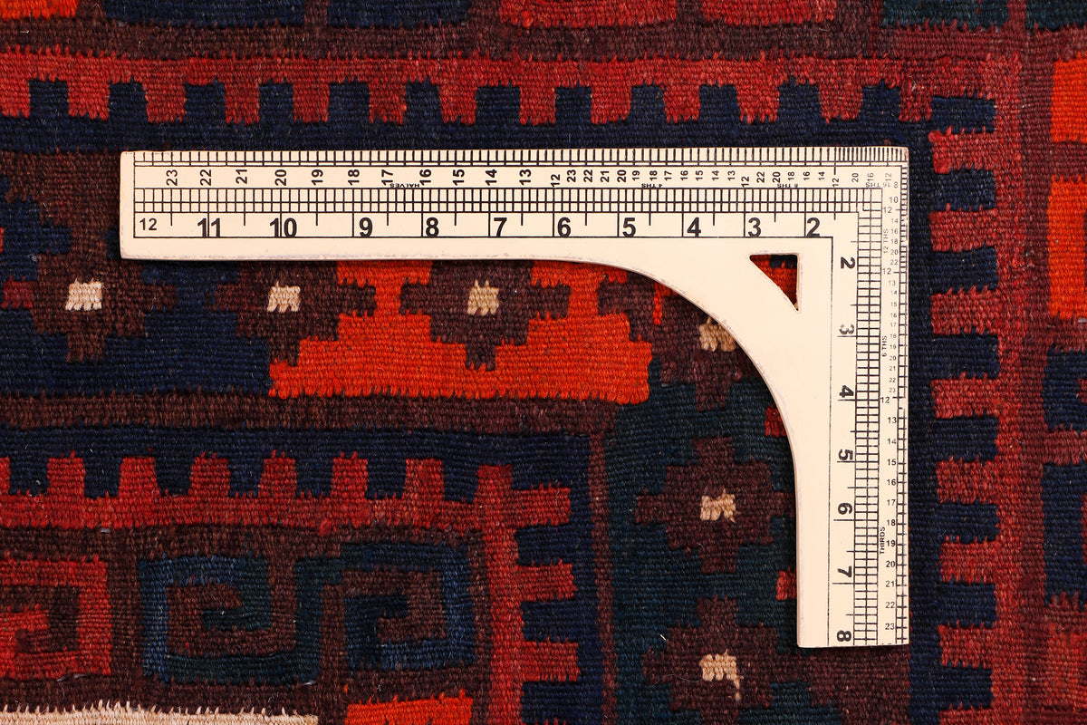 Kilim rug weave close-up with geometric crimson red, navy pattern and cream details